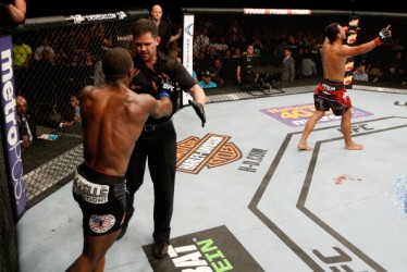 ALBUQUERQUE, NM - JUNE 07: (L-R) Jason High protests his TKO loss to referee Kevin Mulhall as Rafael Dos Anjos celebrates after their lightweight fight during the UFC Fight Night event at Tingley Coliseum on June 7, 2014 in Albuquerque, New Mexico. (Photo by Josh Hedges/Zuffa LLC/Zuffa LLC via Getty Images)