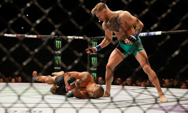 LAS VEGAS, NV - DECEMBER 12: (R-L) Conor McGregor of Ireland punches Jose Aldo of Brazil in their UFC featherweight championship bout during the UFC 194 event inside MGM Grand Garden Arena on December 12, 2015 in Las Vegas, Nevada. (Photo by Christian Petersen/Zuffa LLC/Zuffa LLC via Getty Images)