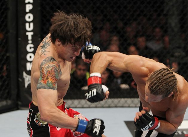 SAN JOSE, CA - NOVEMBER 19: (R-L) Urijah Faber punches Brian Bowles during an UFC Bantamweight bout at the HP Pavillion on November 19, 2011 in San Jose, California. (Photo by Josh Hedges/Zuffa LLC/Zuffa LLC via Getty Images)