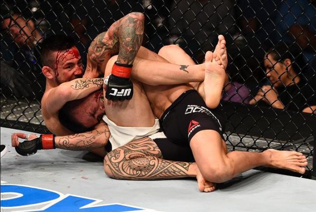 LAS VEGAS, NV - JULY 07: (L-R) Pedro Munhoz of Brazil secures a guillotine choke submission against Russell Doane of the United States in their bantamweight bout during the UFC Fight Night event inside the MGM Grand Garden Arena on July 7, 2016 in Las Vegas, Nevada. (Photo by Jeff Bottari/Zuffa LLC/Zuffa LLC via Getty Images)