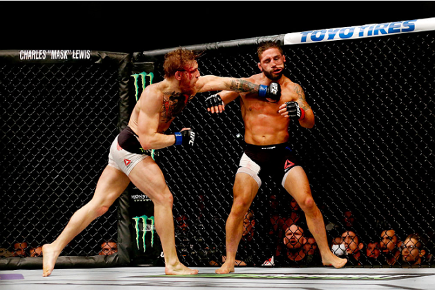 LAS VEGAS, NV - JULY 11: (L-R) Conor McGregor punches Chad Mendes in their UFC interim featherweight title fight during the UFC 189 event inside MGM Grand Garden Arena on July 11, 2015 in Las Vegas, Nevada. (Photo by Christian Petersen/Zuffa LLC/Zuffa LLC via Getty Images) *** Local Caption *** Chad Mendes; Conor McGregor'