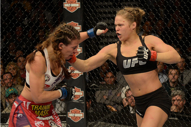 LAS VEGAS, NV - DECEMBER 28: (R-L) Ronda Rousey punches Miesha Tate in their UFC women's bantamweight championship bout during the UFC 168 event at the MGM Grand Garden Arena on December 28, 2013 in Las Vegas, Nevada. (Photo by Donald Miralle/Zuffa LLC/Zuffa LLC via Getty Images) *** Local Caption *** Ronda Rousey; Miesha Tate