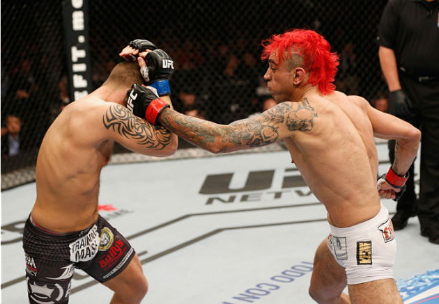 MEXICO CITY, MEXICO - NOVEMBER 15: (R-L) Augusto Montano punches Chris Heatherly in their welterweight bout during the UFC 180 event at Arena Ciudad de Mexico on November 15, 2014 in Mexico City, Mexico. (Photo by Josh Hedges/Zuffa LLC/Zuffa LLC via Getty Images)